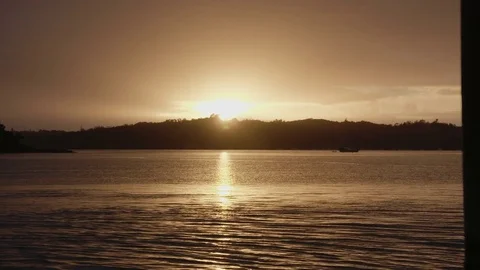 Sunset behind Ocean &amp; Island Stock Footage 83526554