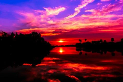 Sunset behind the pond Stock Photos