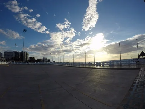 Sunset behind the sea with a park in front. (Time laps) Stock Footage 77336338