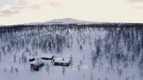 Sunset behind snowy mountain over cabin Stock Footage 73061164