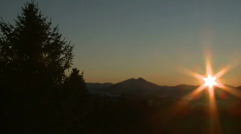 Sunset behind snowy mountains Stock Footage 303452