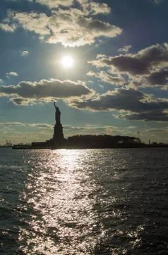 Sunset behind the statue of Liberty Stock Photos