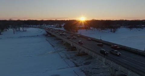 Sunset Behind Traffic On 169 Bridge In Winter Champlin Minnesota Drone Shot Stock Footage 228894674