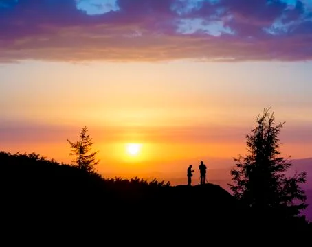 Sunset behind two People Stock Photos