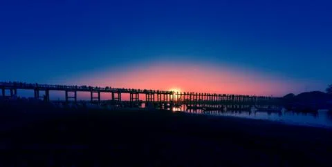 Sunset behind U Bein Bridge over Taungthaman Lake Amarapura Myanmar Stock Photos