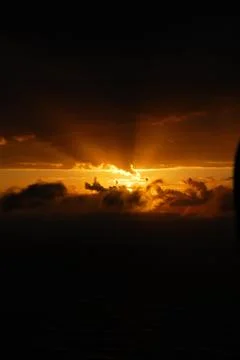 Sunset between clouds on a black background. Landscape view. Stock Photos