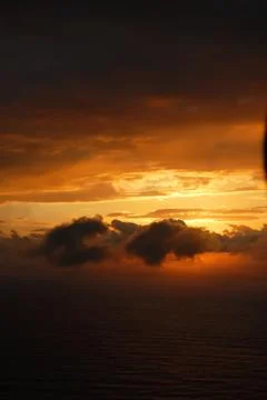 Sunset between clouds on a black background. Landscape view. Stock Photos