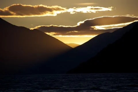 Sunset between mountains with clouds at Queenstown South Island New Zealand Foto stock