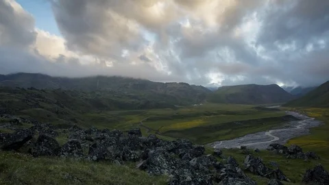Sunset between the mountains at  foot of Mount Elbrus on the glade of Emmanuel Stock Footage 77844886