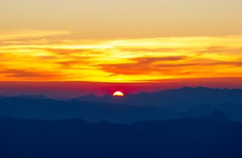 Sunset between mountains. Stock Photos
