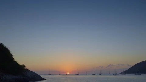 Sunset between two hills in tropical bay with yachts and catamarans Stock Footage 114827195
