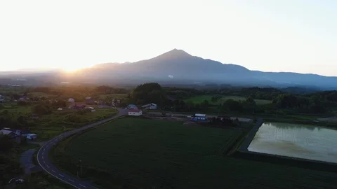Sunset Beyond Mountain, Road And Rice Field Stock Footage 130058718
