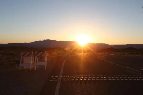Sunset beyond mountains Stock Photos