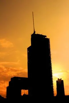 Sunset with big building construction Stock Photos