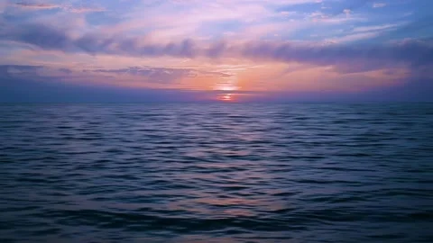 A sunset at the Black Sea in Russia. The clouds lit by the bright gold rays. Stock Footage 153908321