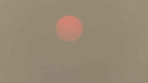 Sunset blocked by wildfire and forest fire smoke in the sky Stock Footage 157612380