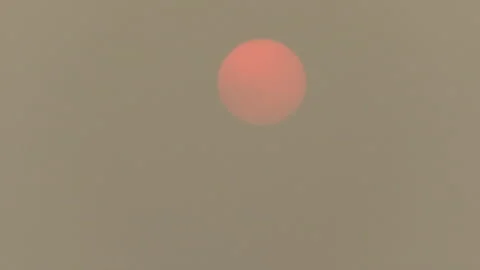 Sunset blocked by wildfire and forest fire smoke in the sky Stock Footage 157612409