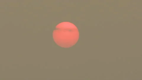 Sunset blocked by wildfire and forest fire smoke in the sky Stock Footage 157612673