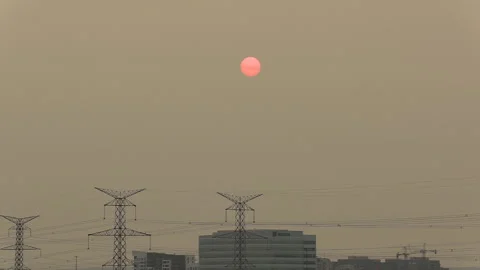 Sunset blocked by wildfire and forest fire smoke in the sky Stock Footage 157612696