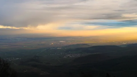 Sunset with blue and orange sunrays with deep Alsace valley Stock Footage 124482982