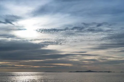 Sunset with blue fluffy cloudy sky and sea overlooking the island, Beautiful Stock Photos