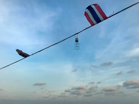 Sunset blue sky with clouds have Thai and Malaysia flag and light blub Stock Photos