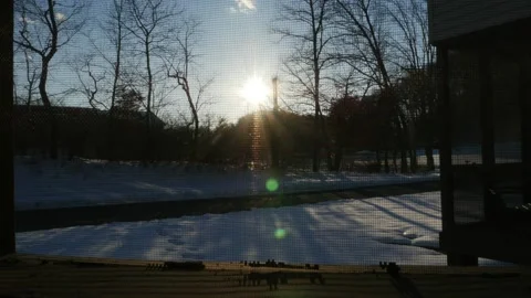 Sunset Blue sky time lapse through screen window in cabin during winter Stock Footage 232975049