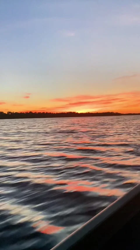 Sunset Boat Ride Over Calm Coastal Waters Stock Footage 320186732
