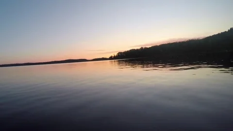 Sunset boating on a lake Stock Footage 77807786