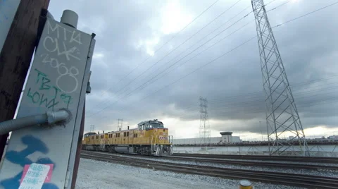 Sunset breaks through Storm Clouds Train with Train Tracks and Graffiti Video stock 60700820