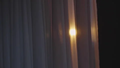 Sunset breaks through white curtains to illuminate room Stock Footage 243576161
