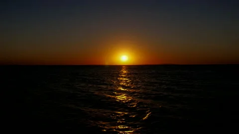 Sunset. The bright sun sets over the horizon in the sea. Stock Footage 142604614
