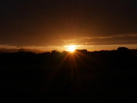 Sunset with a bright sun in the sky Stock Photos