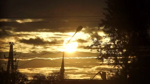 Sunset bright sun through the clouds against the background of city electric Stock Footage 78122787