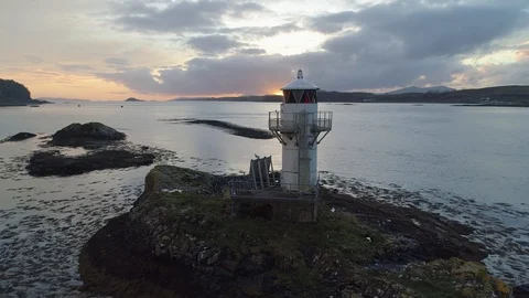 Sunset bursts through lighthouse with seagul flying off Stock Footage 102411788