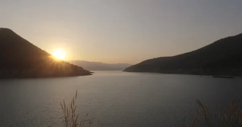 Sunset on the calm lake between Mountains and valleys Stock Footage 155732194