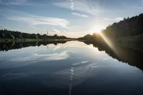 Sunset on a calm river, evening on the Western Dvina river Stock Photos