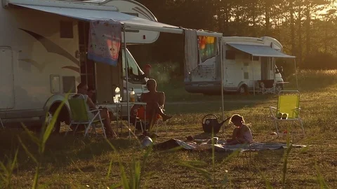 Sunset at campsite, modern caravan camper. Family adventure trip holiday Video stock 80476510