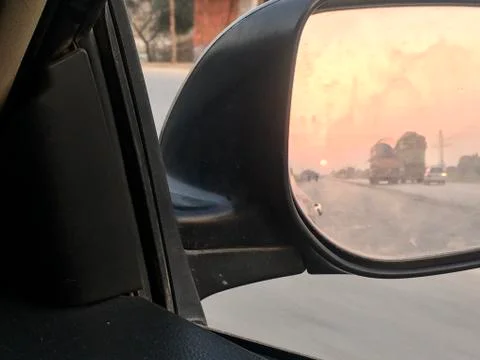 Sunset in car mirror Stock Photos
