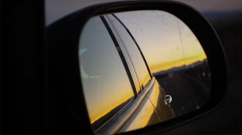 Sunset in car mirror Stock Photos