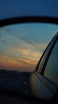 Sunset in the car mirror 스톡 사진