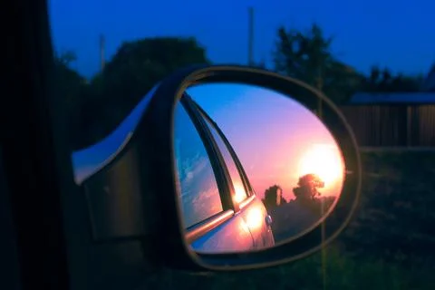 Sunset from the car in the mirror 写真素材