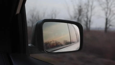 Sunset in car mirror reflection. riding by highway Stock Footage 132692401