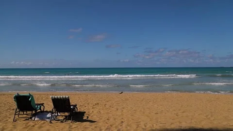 Sunset on the Caribbean beach with two sunbed, picnic at the ocean. Stock Footage 201912145