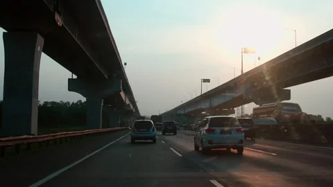 Sunset casts golden glow over busy highway Stock Footage 337834460