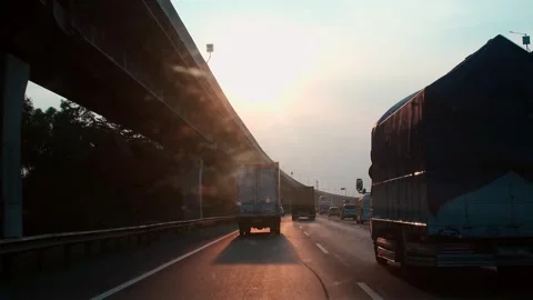 Sunset casts golden glow over busy highway. Stock Footage 337834519