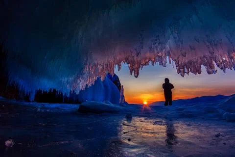 Sunset in a cave grotto with icicles in the winter on Olkhon Island, Lake Baikal Stock Photos