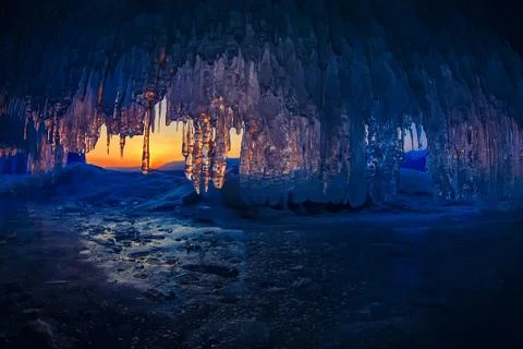 Sunset in a cave grotto with icicles in the winter on Olkhon Island, Lake Baikal Stock Photos