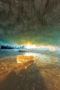 Sunset in a cave grotto with icicles in the winter on Olkhon Island, Lake Baikal Stock Photos