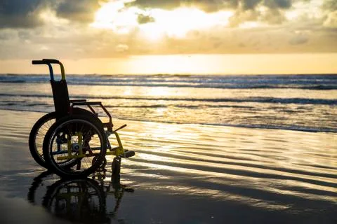 Sunset childlike wheelchair horizon sand Stock Photos